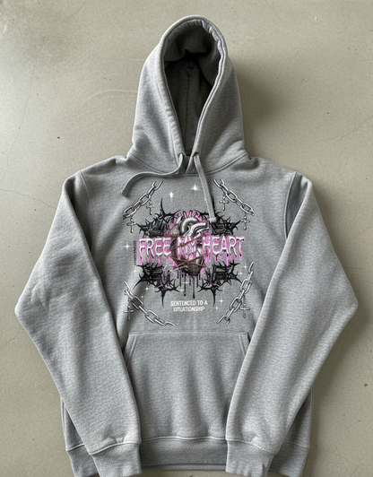 Gray hoodie with graphic design and text on a beige background