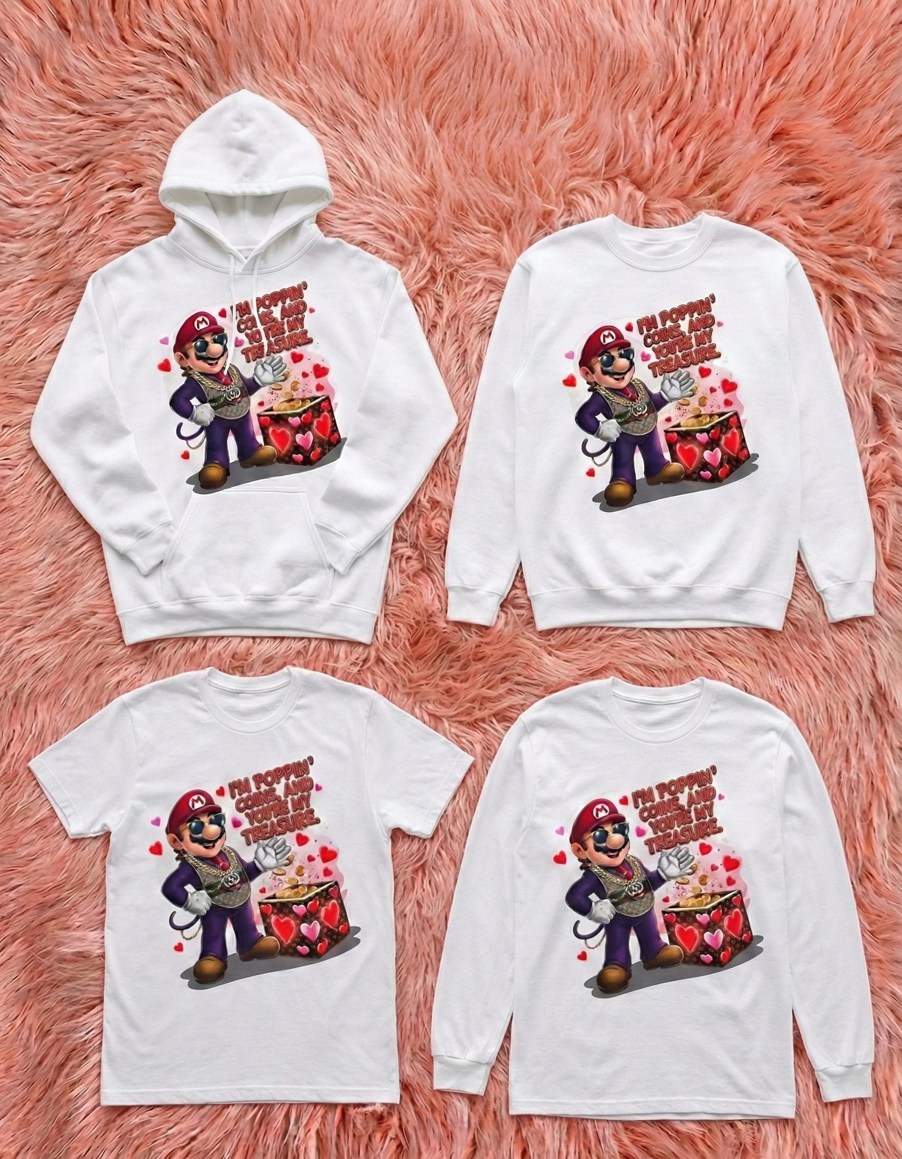 Four white shirts with a cartoon character and text on a pink fluffy background