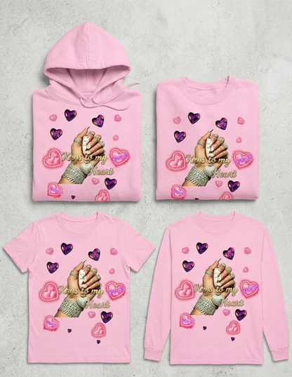 Set of pink hoodies and t-shirts with heart and hand design on a gray background