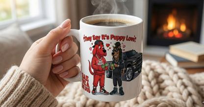 Hand holding a mug with a cartoon design of a dog and a car, in front of a fireplace.