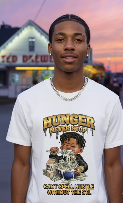 Person wearing a white t-shirt with a graphic design and text, standing in front of a building with a sunset sky.