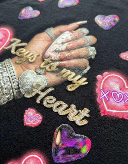 Black fabric with gold 'Keys to my Heart' text, hands, and heart-shaped designs.