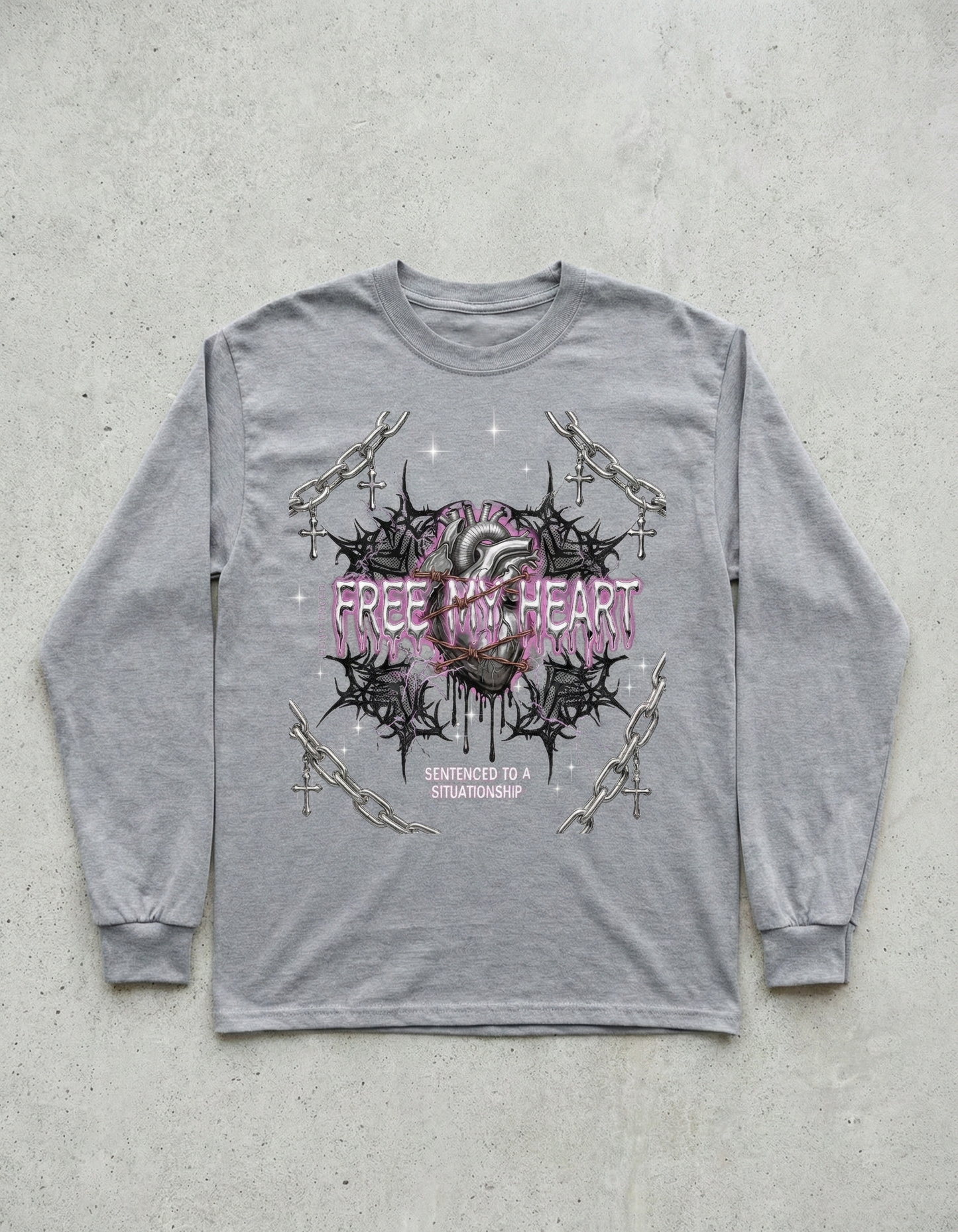 Gray long-sleeve shirt with a graphic design on a concrete surface