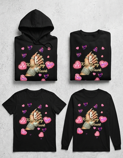 Four black shirts with a design of hands holding hearts and text on a gray background