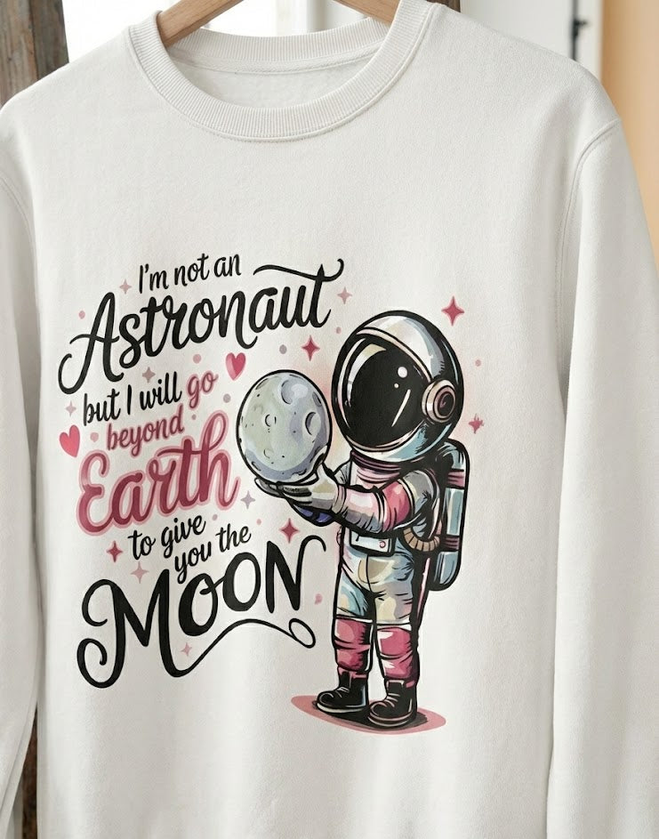 White sweatshirt with an astronaut graphic and text on a hanger.