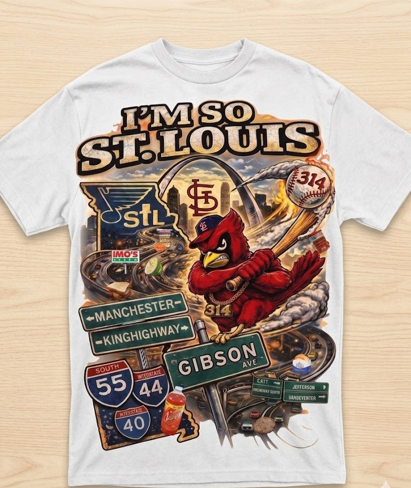 White t-shirt with St. Louis-themed graphics and text on a wooden surface