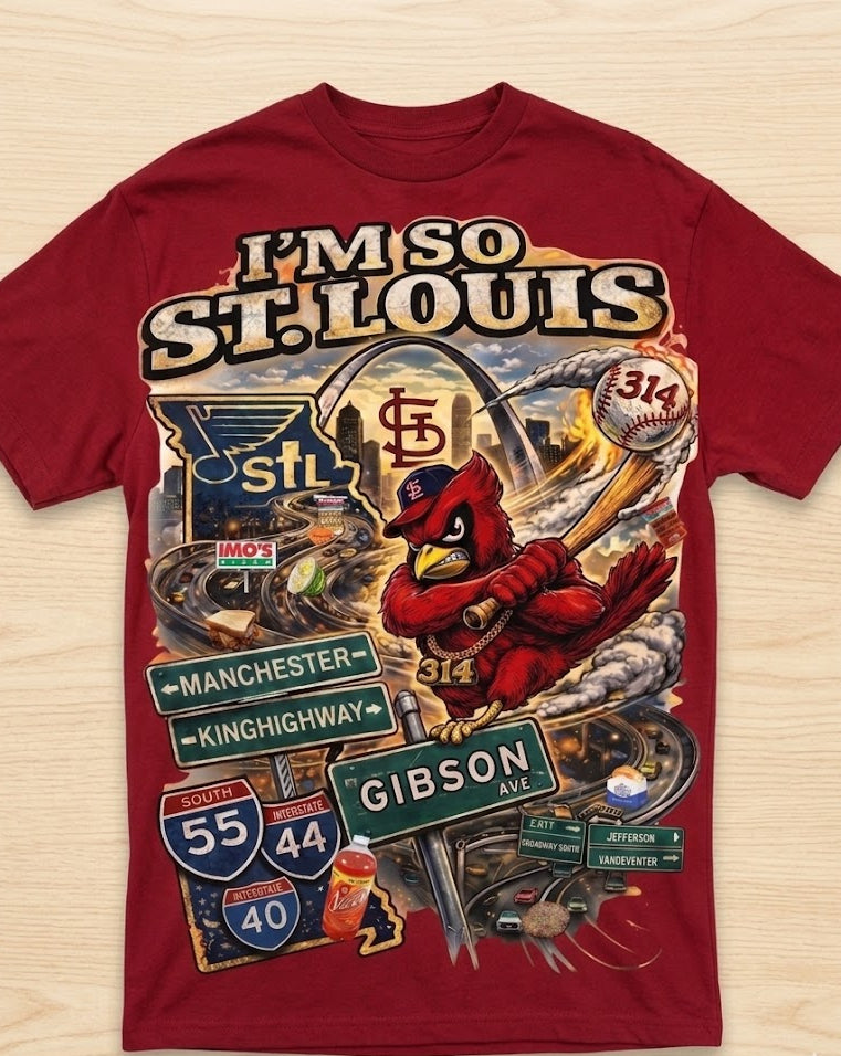 Red t-shirt with St. Louis-themed graphics and text on a wooden surface